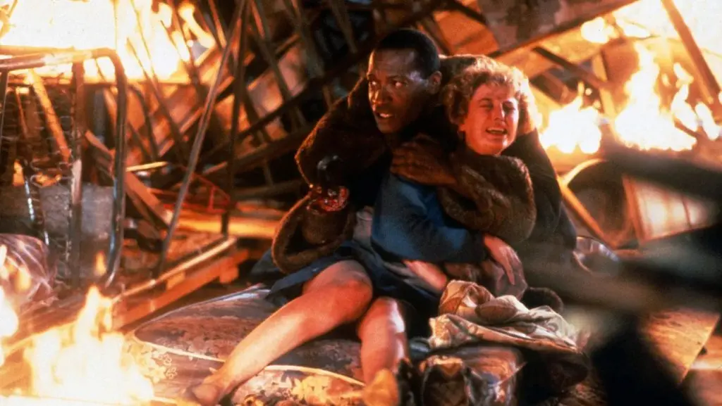 Tony Todd as Candyman, holding a woman in fire in Candyman