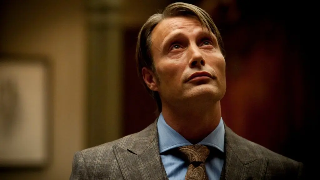 Mads Mikkelsen looking up, as Hannibal Lecter.