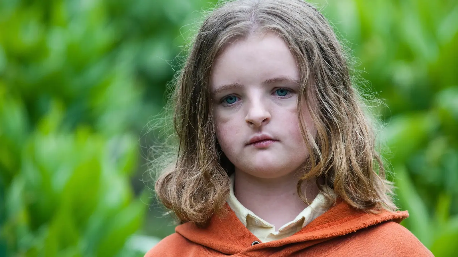 Milly Shapiro in an orange coat in Hereditary.