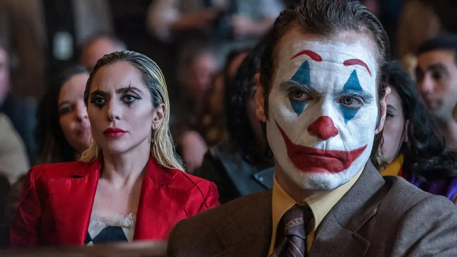 Lady Gaga and Joaquin Phoenix in a Joker 2 courtroom scene.