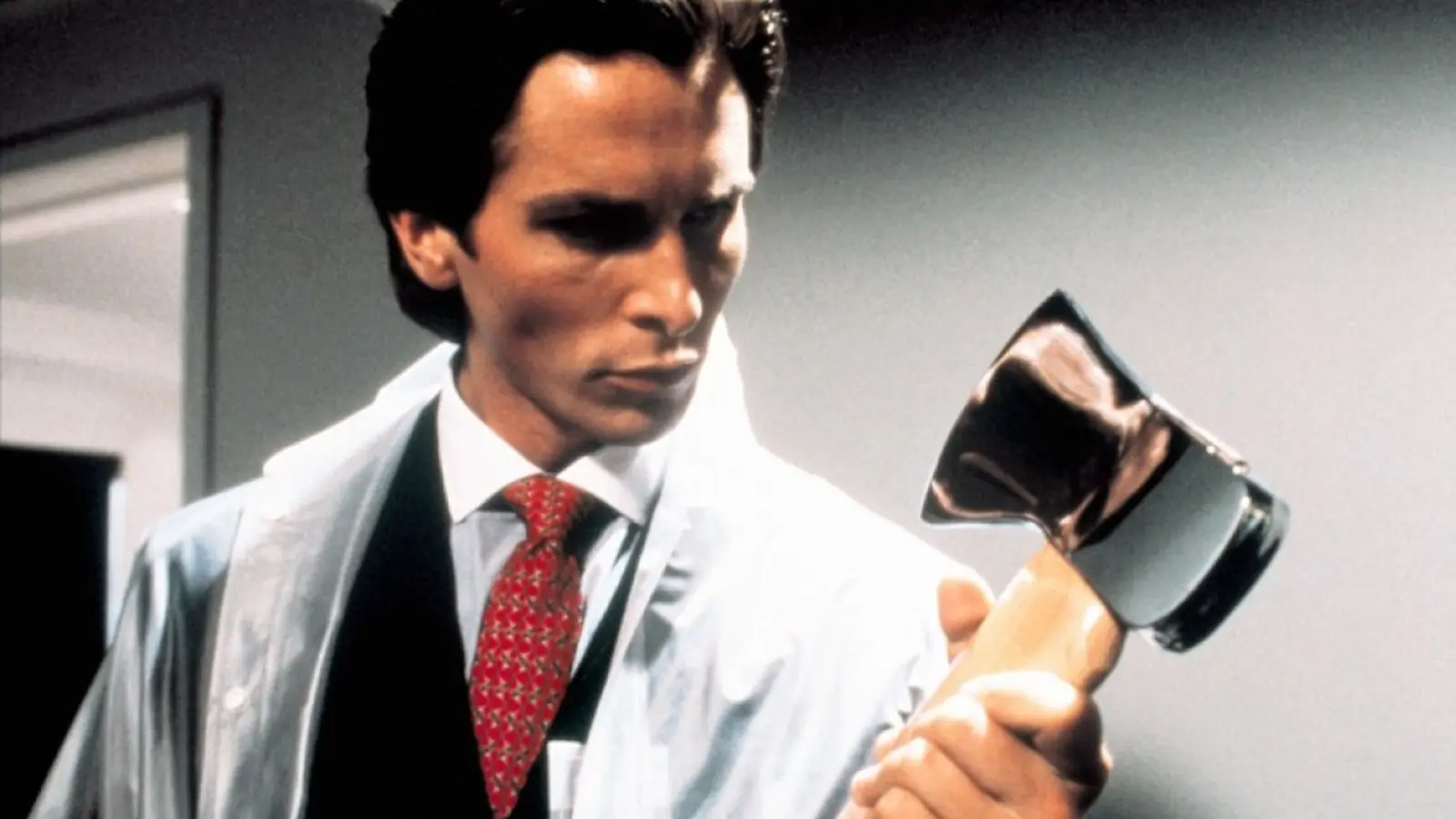 Christian Bale holding an axe in American Psycho.