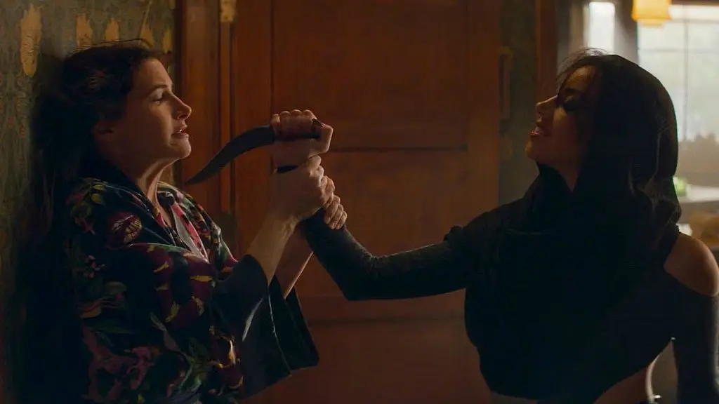 Rio, aka Death, holding a knife to Agatha