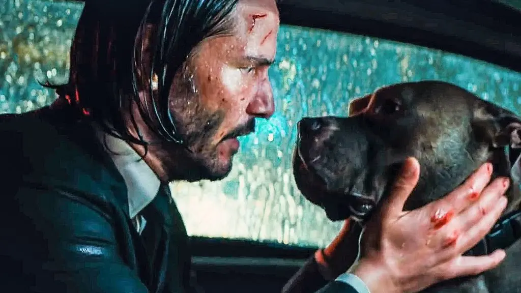 John Wick holds a dog's face