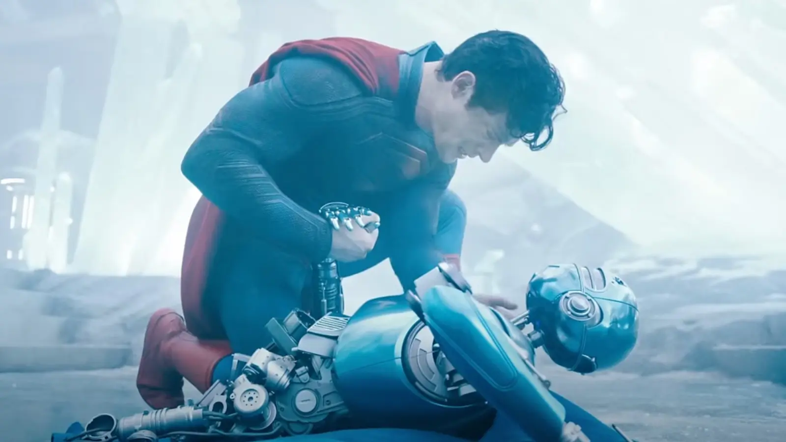 Superman kneels over a robot.