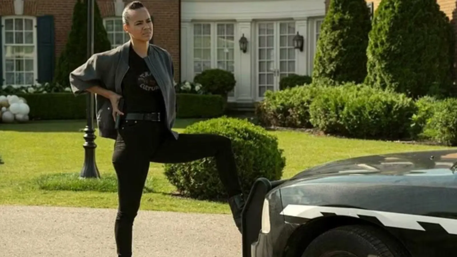 Maria Stern with her foot on a car in Reacher.